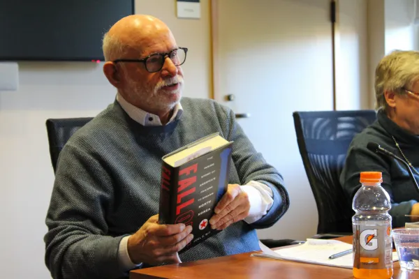 Joel Wit holding his book, titled "Fallout."