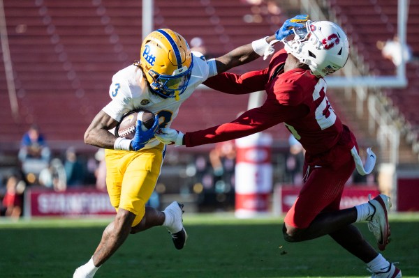 Pittsburgh wide receiver Cataurus
Hicks stiff arms a Stanford defender on a 14-yard pass from Pittsburgh quarterback Mason Heintschel in the fourth quarter. Heintschel threw for 304 yards en route to a 35-20 victory while Stanford quarterback Ben Gulbranson's three interceptions led sophomore Elijah Brown to enter the game for the final quarter. (Photo: IMOGEN LEE/The Stanford Daily)
