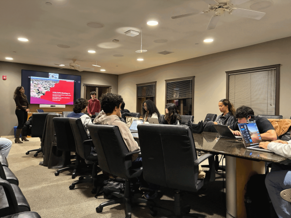 The UGS seated around a table for its weekly meeting.