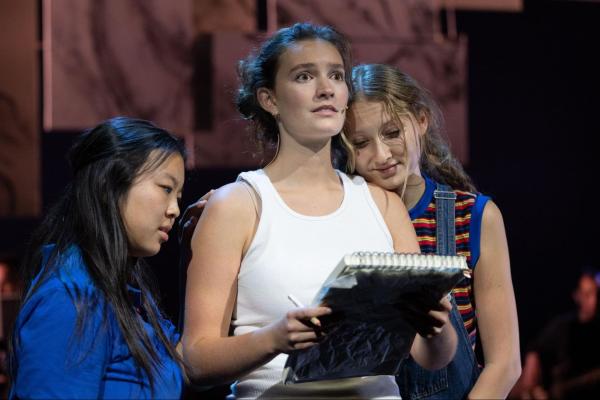 From left to right: Medium Alison (Alexis Tuchinda ’28), Adult Alison (Lyle Belger ’25 MA ’26), and Small Alison (Maddie Garfinkel ’28) stand together on stage.