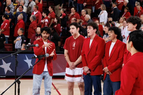 Ethan Kitch, in his basketball gear, sings the National Anthem with his fellow Mendicants members before a game against Cal at Maples Pavilion on Jan. 24. Kitch was able to walk onto the team during his first week at Stanford.(Photo: BOB DREBIN/ISI Photos)