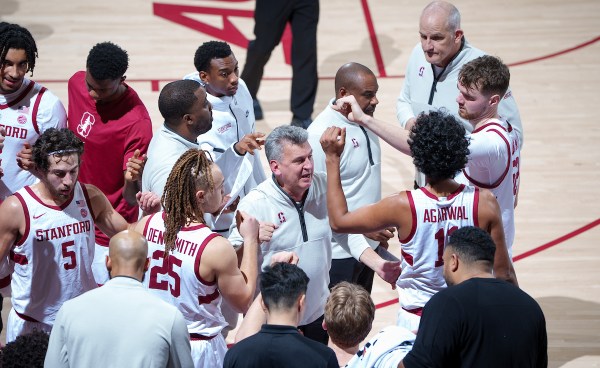 The Stanford men's basketball team huddles up during a game against the University of Louisville at Maples Pavilion on Jan. 2. The Cardinal begin a crucial set of games Wednesday night against North Carolina. (Photo: JOHN TODD/ISI Photos)