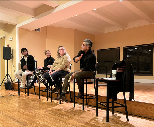 Panelists sit in a line.
