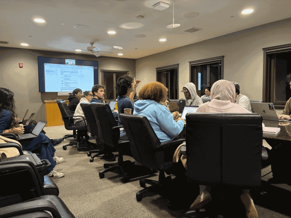 Members of the undergraduate senate sit at a conference table.