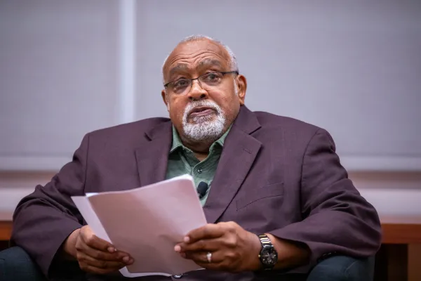 Glenn Loury seated at a speaker event