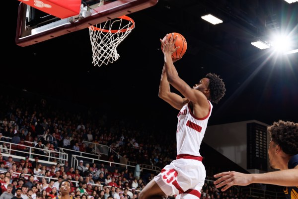 Basketball player goes for a layup.