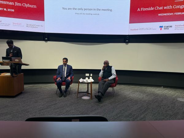 Ro Khanna and Jim Clyburn sit at the front of a classroom. A moderator stands at a podium next to them.