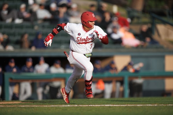 Baseball player runs on field.