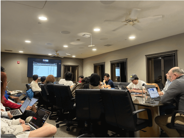 The UGS reviews a spreadsheet at its Feb. 4 meeting. (Photo: REBECCA BYERS/The Stanford Daily)