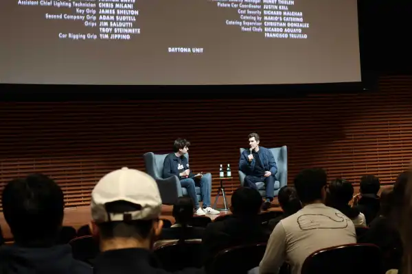 Daniel Rashes '26 discusses 'F1' with director Joseph Kosinski '96 after the FLiCKS screening ends.