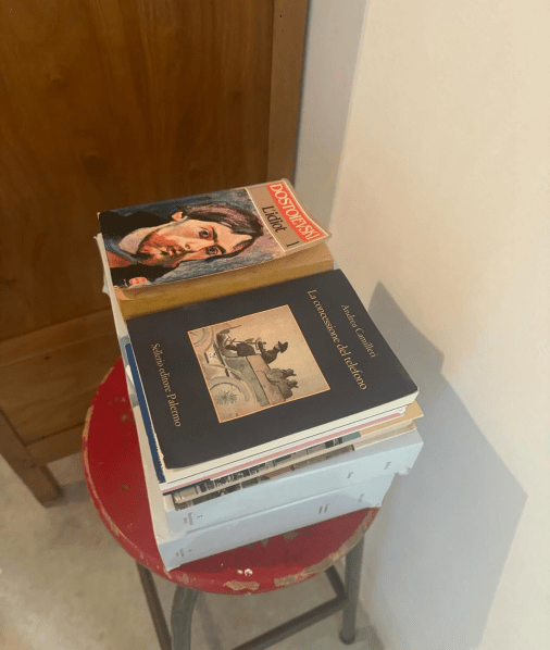 A stack of books on a red chair