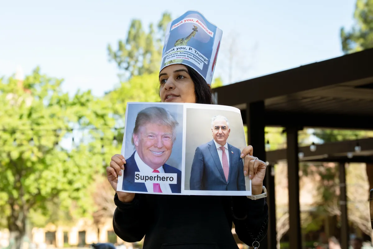 Stanford protestors meet counterprotestors in rally against Iran war 1 A protestor holds up a poster praising Trump and Pahlavi