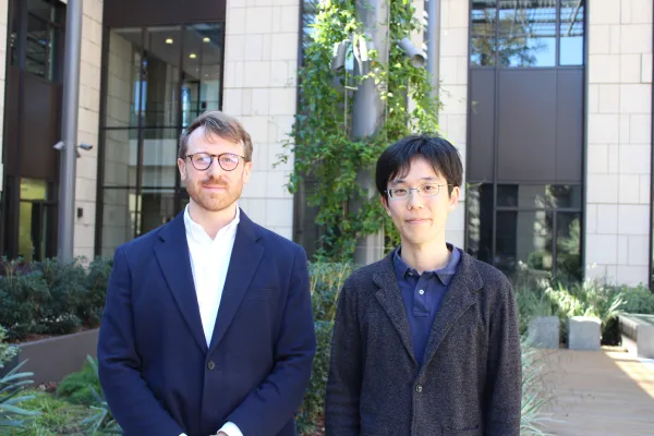 Eric Baldwin (left) and Takuma Iwasaki (right) pose for a photo.