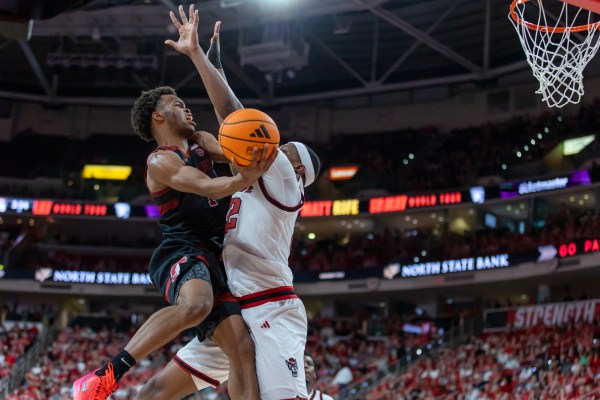 Ebuka Okorie takes layup with defender in front of him.