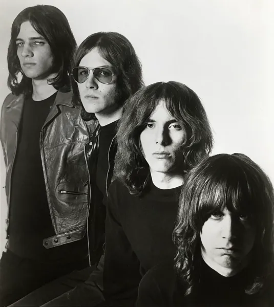 The Stooges stand in a line up.