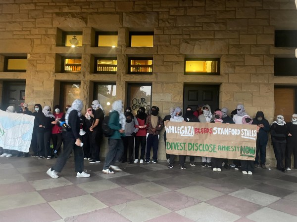 Protesters walk past Building 10.