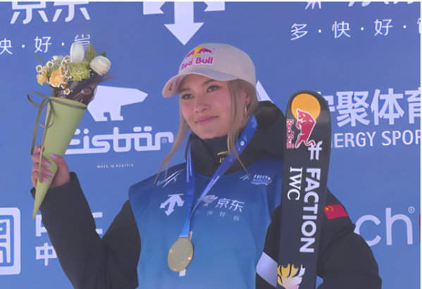 Eileen Gu poses with her gold medal from the 2023-24 FIS Halfpipe World Cup Genting competition.