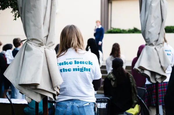 A student in a shirt that reads 'take back the night.'