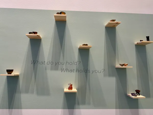 Ceramic bowls made by community members are displayed in the front of the Anderson Collection’s new exhibit, “1,000 Ways to Hold” by Erika Chong Shuch.