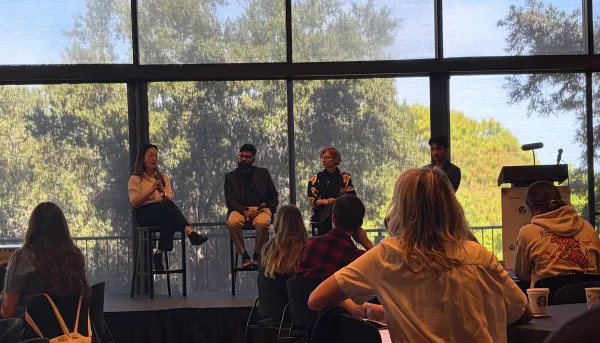 Panelists discuss finance in Tresidder Oak Lounge at the Food4Thought festival
