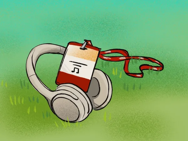 Headphones with an Admit Weekend badge and lanyard.