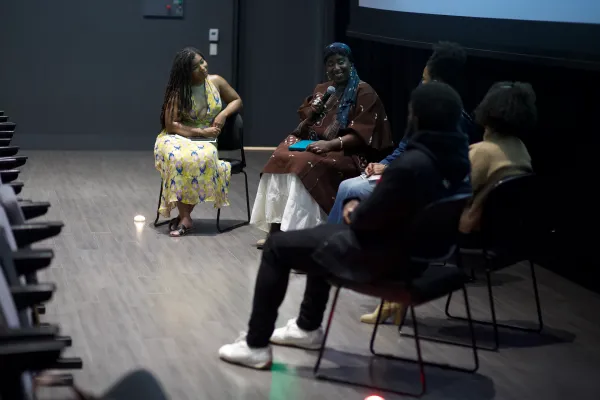 A panel of speakers sits in Oshman Hall for the inaugural Black women's film festival at Stanford.