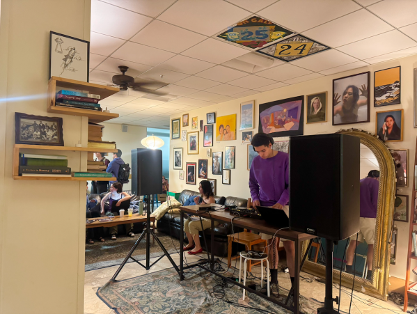 A DJ at a cafe setting up equipment.