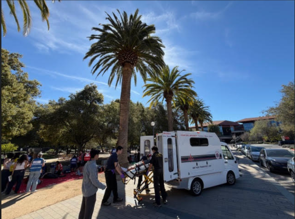 EMTs loading a patient onto a medical transportation vehicle.