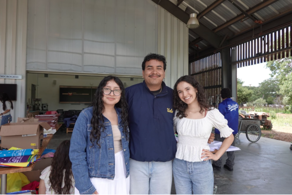 Farmworker symposium directors pose in front of barn.