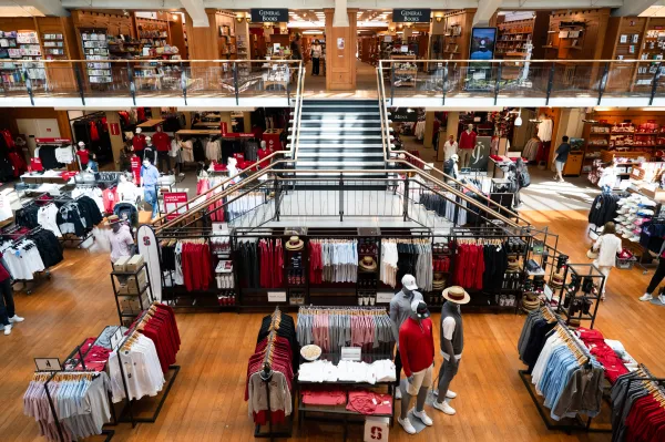 Overhead photo centering the Stanford bookstore staircase, surrounded by merchandise on the first floor and books on the second floor.