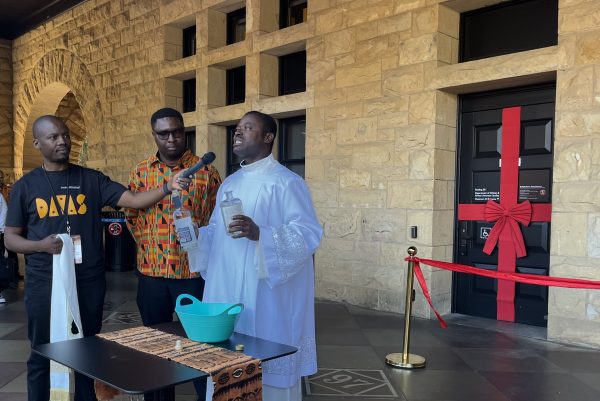 Samuel Nkanash gives a prayer in front of Building 80