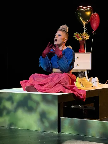 Antonio, played by César Valenzuela, faces the audience on stage