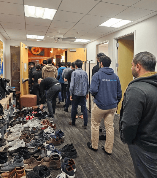 A line of people gather for prayer