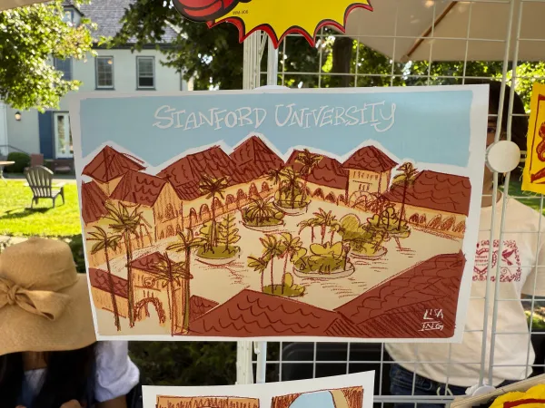 A printed illustration of Main Quad from above, on display at a booth