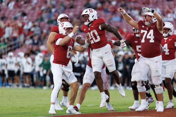 Micah Ford celebrates a touchdown with teammates Davis Warren #8 and Fisher Anderson #74 during a game against University of Hawaii. Ford became the first Cardinal player to record 90+ rushing yards and three touchdowns in a game since 2017. (Photo: BOB DREBIN/ISI Photos)