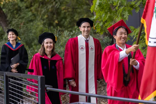 President Jonathan Levin and Provost Jenny Martinez walk into convocation. (Photo courtesy of Andrew Brodhead/Stanford Report)