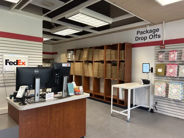 This is a photo of inside Postal Annex, showing a front counter and shelves of flattened boxes.