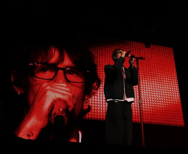 Singer holds the microphone while on stage.