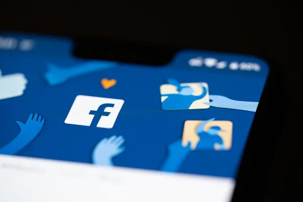 A graphic showing the Facebook app on a mobile phone.