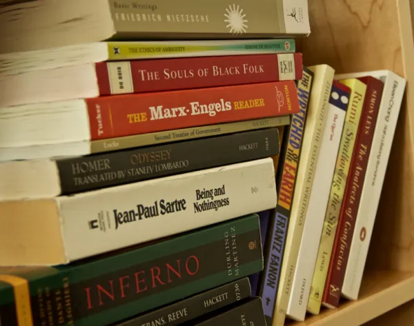 A stack of books on a shelf.