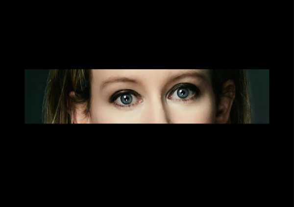 A close-up of Elizabeth Holmes' wide blue eyes.