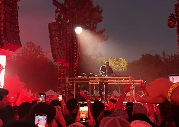 Kaytranada performs under a spotlight at the Sleeping on Gems Fest in San Jose as fans raise their phones to capture the set. (Courtesy of Josh Buenviaje)